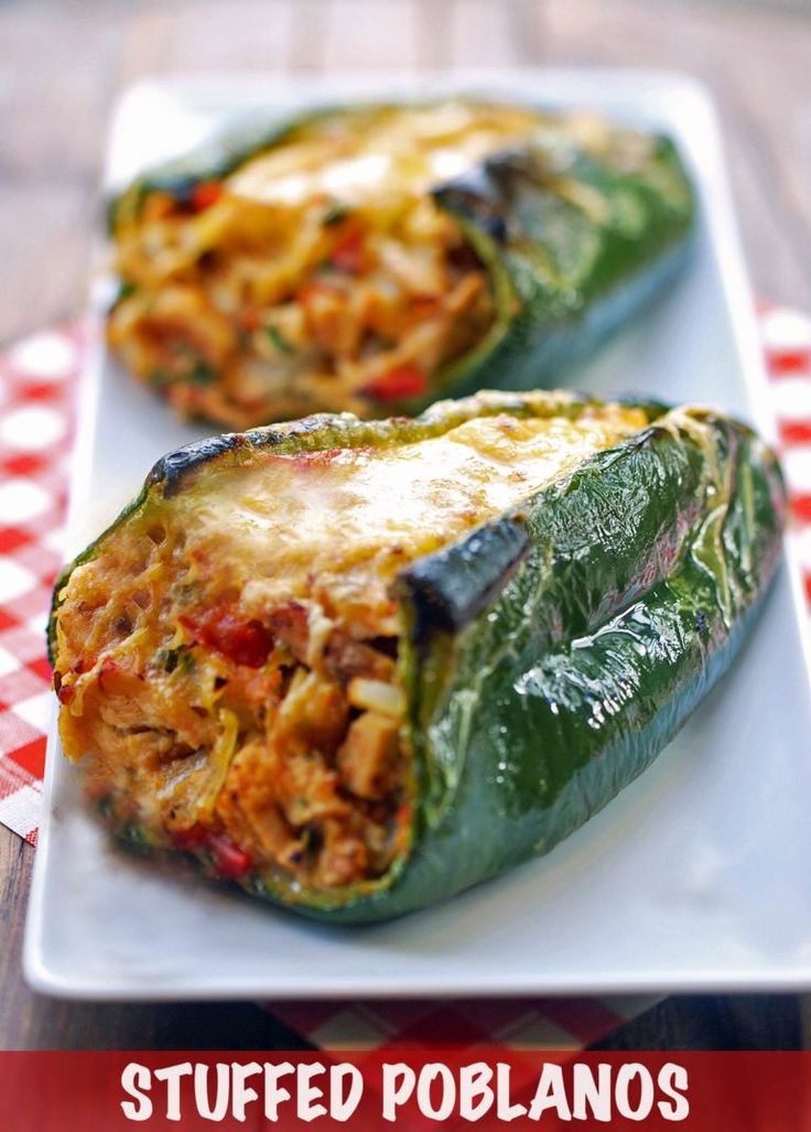 chicken stuffed poblaano peppers on a white plate with the title text above it