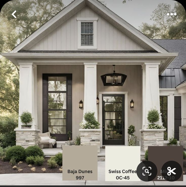 the exterior of a house with white trim and black shutters is shown in this color scheme