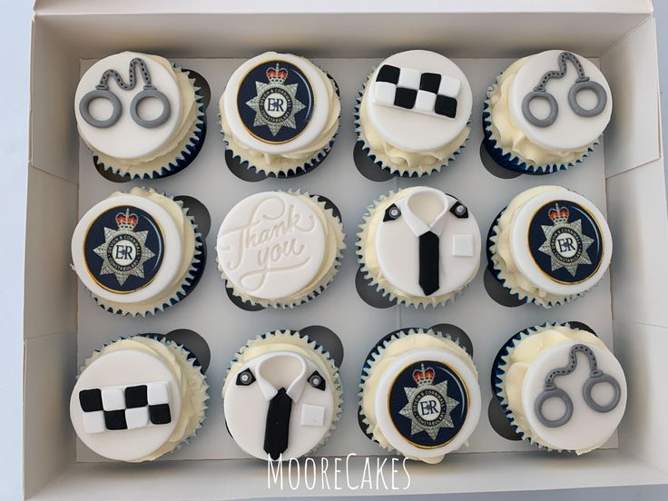 twelve cupcakes in a box decorated like police officers