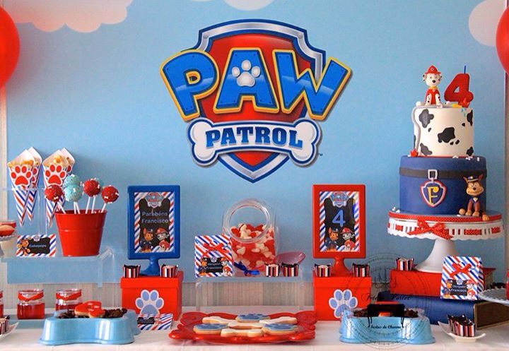 a table topped with lots of cakes and desserts covered in red, white and blue icing