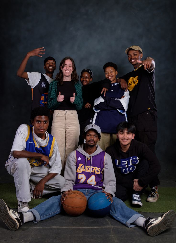 a group of people posing for a photo with a basketball ball in front of them