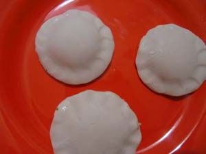 three dumplings are sitting on a red plate