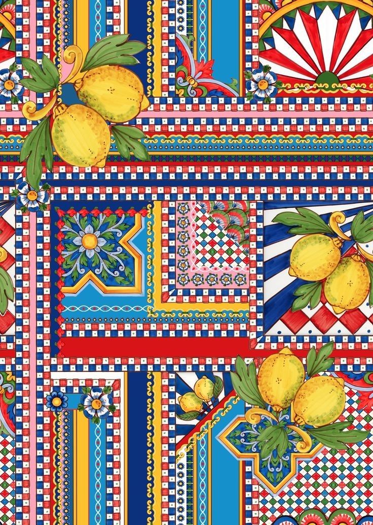 a colorful pattern with lemons and other fruit on the tablecloth, as well as an ornament