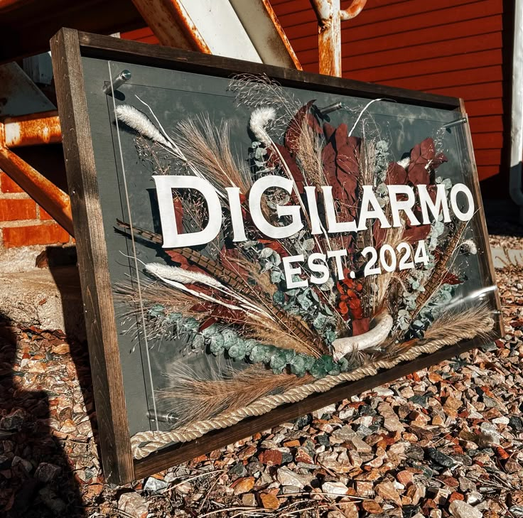 there is a sign that says diglarmo est 2024 on the side of a building