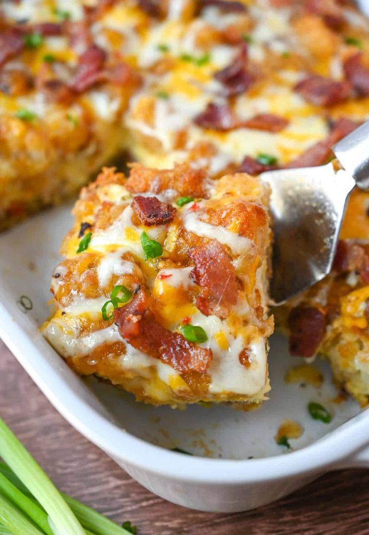 a close up of a casserole dish on a table with a spatula