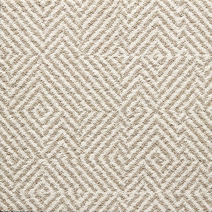 a close up view of a white and beige carpet with diamond shapes on it's surface