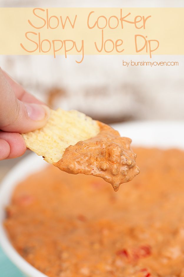 a hand holding a cracker over a bowl of soup with the words slow cooker sloppy joe dip on it