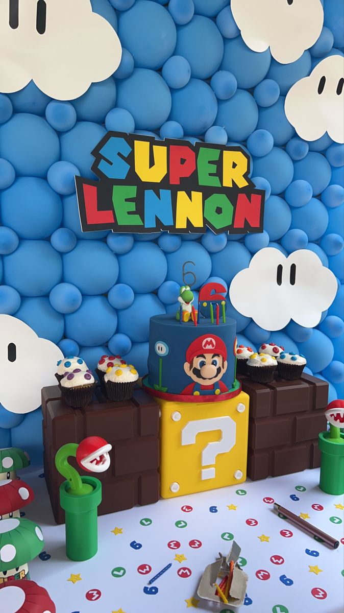 a super mario birthday party with cupcakes and decorations