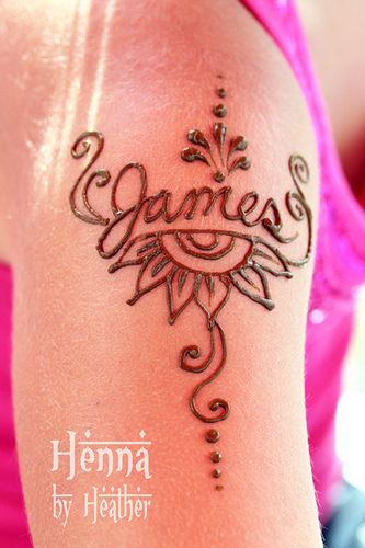 henna tattoo designs on the arm and back of a woman's arm, with words written in cursive writing