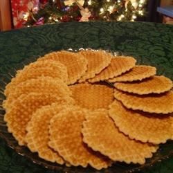 crackers arranged on a glass plate in front of a christmas tree