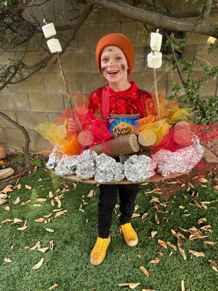 Campfire Halloween costume. Tulle (flames), pool noodles  (logs) foil (rocks) Campfire Parade Float, Dress Like A Camper Day At School, Campfire Halloween Costume, Smores Costume Families, Hiker Halloween Costume, Camper Costume Ideas, Campfire Costume Diy, S’mores Costume Diy, Camper Halloween Costume