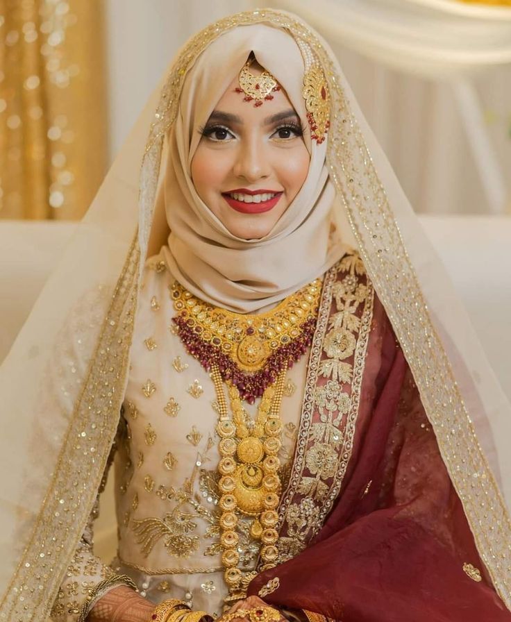 a woman in a wedding outfit is smiling for the camera