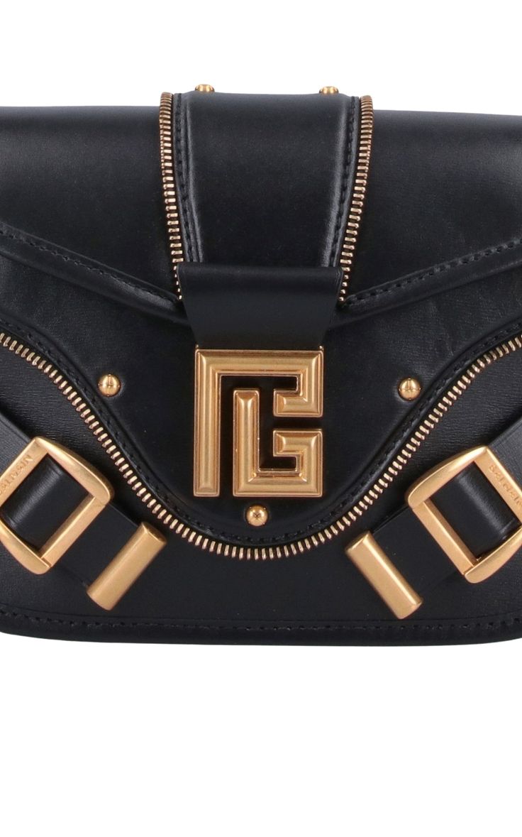 The Balmain Blaze Leather Shoulder Bag in black boasts an adjustable top leather shoulder strap for added convenience, secured with a snap flap closure. Its gold flap logo and double buckle detail on the front add a touch of sophistication. Plus, the bag features a flat back pocket and interior flat pocket within the spacious main compartment. Size and fit: H 6"/15cm X L 9"/23cm X D 2.75"/7 cmStrap span: 24.9"/63 cmComposition: 100% Calfskin LeatherHardware: Golden metalSignature dust bag includ Designer Crossbody Shoulder Bag With Gold-tone Hardware, Luxury Bag With Logo Hardware And Flap, Luxury Bags With Logo Hardware And Flap, Black Leather Flap Bag With Logo Hardware, Luxury Flap Shoulder Bag, Luxury Bucket Shoulder Bag With Metal Hardware, Chic Evening Flap Bag With Logo Hardware, Elegant Crossbody Satchel With Logo Hardware, Designer Gold Shoulder Bag With Brass Hardware