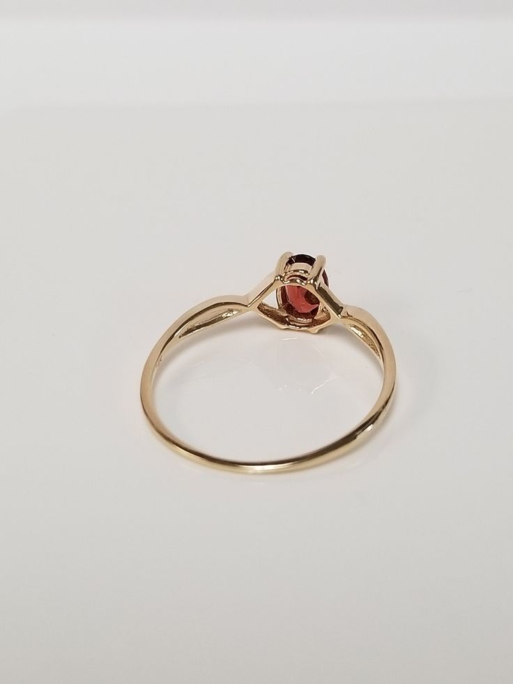 "Thanks for shopping our vintage estate store. We tend to sell well below wholesale and truly hope you enjoy all of our items. Many of the items are one of a kind, so please enjoy scrolling through the pictures and hopefully something will catch your eye. Brown spots are from reflections. Estate 14k yellow gold natural .50ct garnet midi or birthstone ring. Ring size: 7 Setting: 6mm by 4mm 1/4\" Band width: 1mm Weight: 1.14 grams Beautiful ring. Marked 14k." Classic Cluster Birthstone Ring, Classic Oval Solitaire Birthstone Ring, Classic 14k Gold Diamond Ring With Oval Cabochon, Classic Gold Oval Birthstone Ring, Oval Wedding Rings With Certificate Of Authenticity, Vintage Oval Birthstone Diamond Ring, Classic Oval Yellow Gold Birthstone Ring, Oval Ruby Ring Stamped 14k For Anniversary, Oval Ruby Ring For Anniversary Stamped 14k