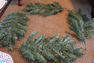 two wreaths are laying on the floor next to each other with needles sticking out of them