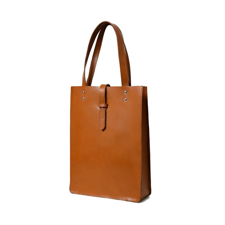 Embrace pure elegance with our artisan-crafted shopper tote. Woven from the very soul of buffalo leather, it doesn't just carry your belongings, but your style and confidence too. Its timeless brown shade, a silent nod to tradition, blends seamlessly with its contemporary design. Grasping the handles feels like shaking hands with timeless luxury. Revel in life's small moments of grandeur with every step, showcasing the world that you have an impeccable taste for both fashion and life's pleasures Rectangular Vegetable Tanned Leather Bags For Work, Rectangular Vegetable Tanned Leather Work Bag, Vegetable Tanned Leather Satchel With Leather Handles For Shopping, Shopping Satchel With Leather Handles And Vegetable Tanned Leather, Timeless Smooth Grain Shoulder Bag For Shopping, Classic Dark Tan Bags For Daily Use, Elegant Dark Tan Shoulder Bag With Leather Handles, Timeless Brown Satchel With Double Handles, Classic Everyday Bag In Vegetable Tanned Leather