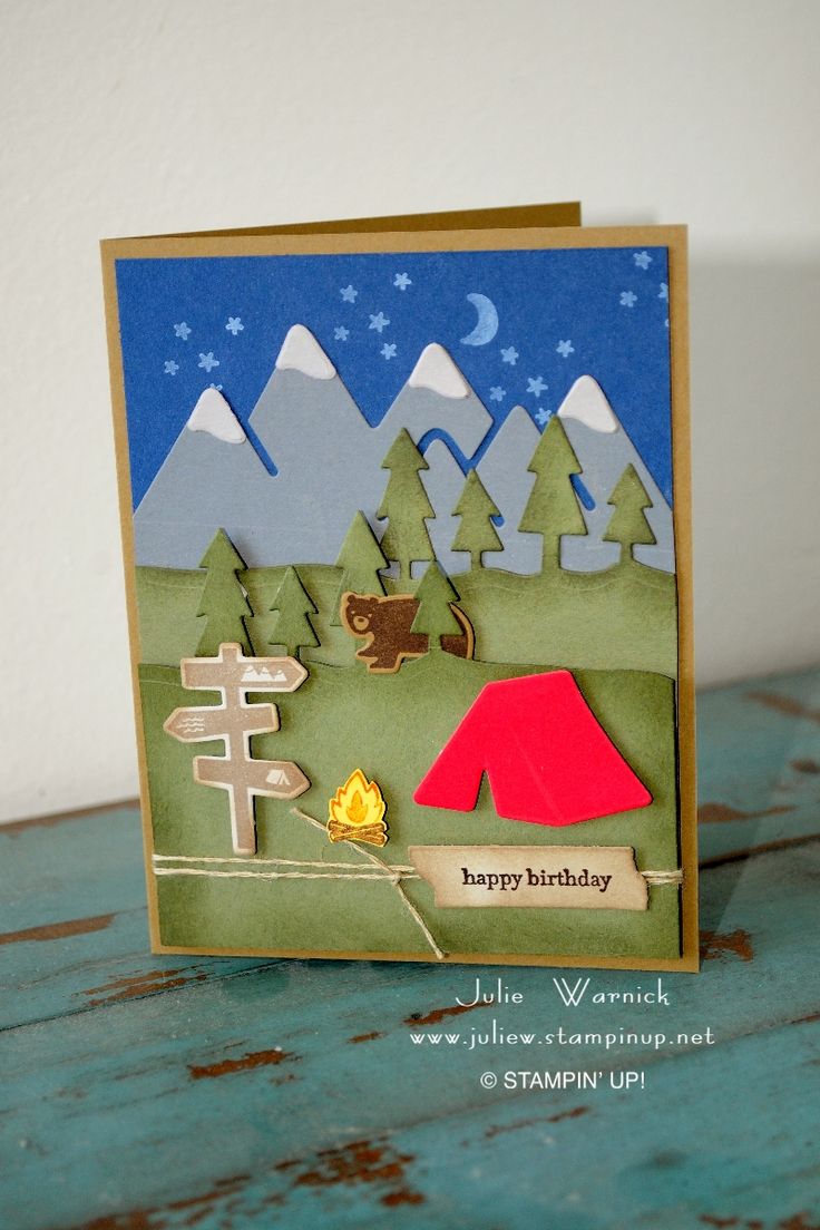 a handmade birthday card with a campfire and tent in the woods on it