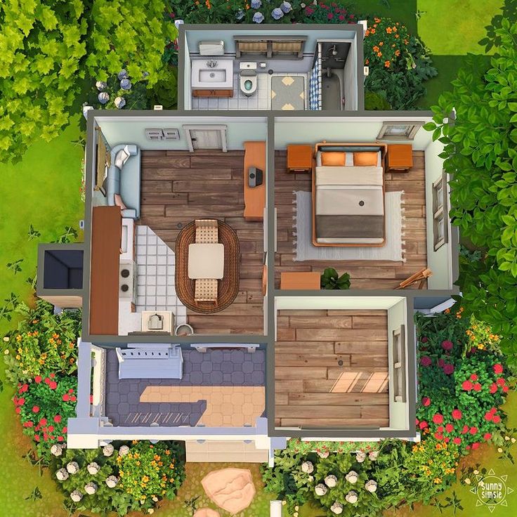 an aerial view of a small house in the middle of some trees and bushes with flowers around it