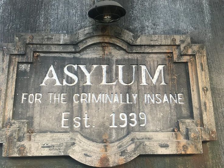 an old sign on the side of a building that says asylum for the formally insane est 1939