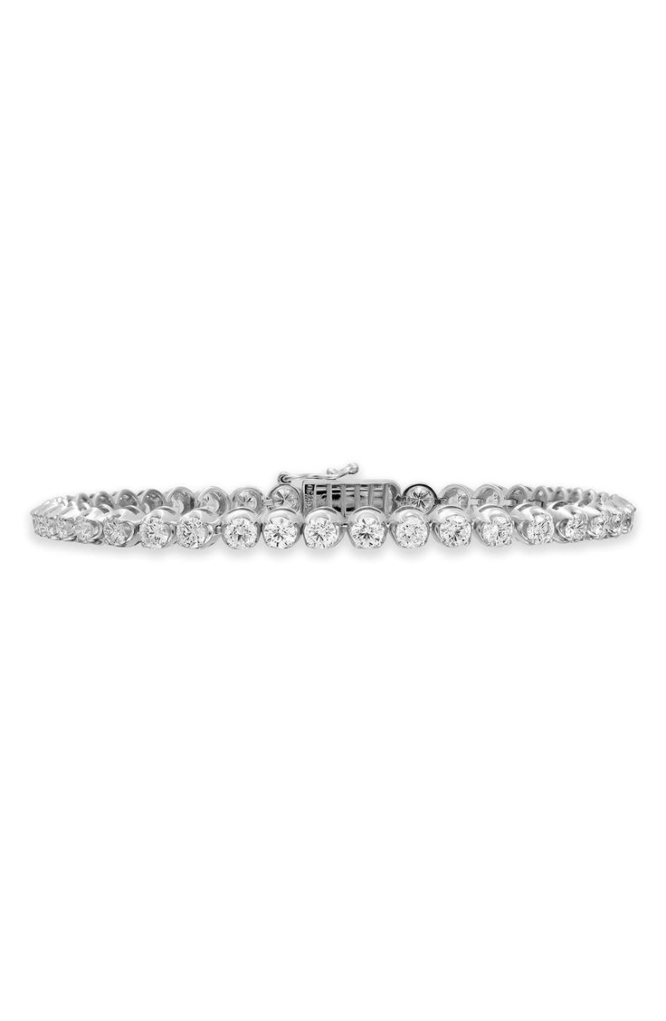 A total of 61 round diamonds dazzle on this handcrafted tennis bracelet set in icy 18-karat gold. 7" inner circumference Hinge with box-clasp closure Total diamond weight: 4.59ct. Color: G Clarity: VS 18k gold/diamond Imported >Diamond Guide Luxury Lab Grown Diamond Bracelet For Formal Occasions, Luxury Lab-grown Diamond Bracelet For Formal Occasions, Luxury Platinum Tennis Bracelet With Prong Setting, Platinum Tennis Bracelet With Diamond Accents, Elegant Round Lab Grown Diamond Tennis Bracelet, Luxury Lab Grown Diamond Bracelet In Diamond White, Luxury Lab-grown Diamond Bracelet In Diamond White, Luxury Lab Grown Diamond Bracelet, Dazzling White Gold Tennis Bracelet In Platinum