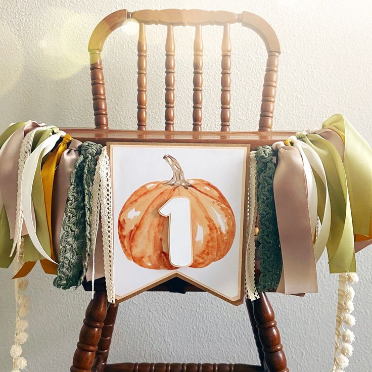 a chair decorated with ribbons and a pumpkin