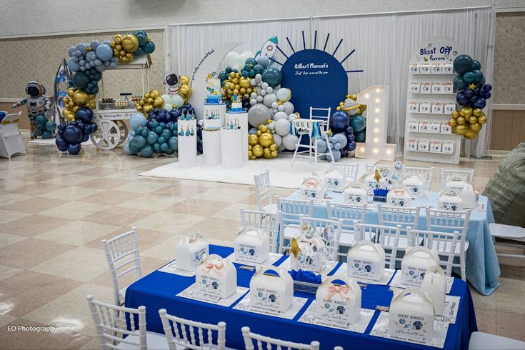 tables and chairs are set up for an event with balloons in the shape of letters