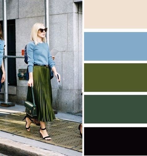 two women walking down the street in front of a building with blue and green colors