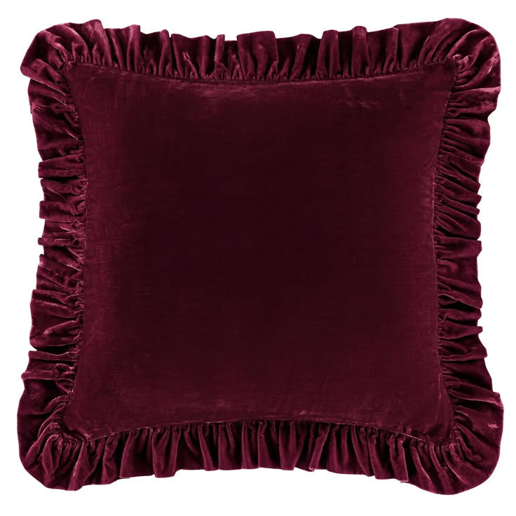 a velvet pillow with ruffles on the front and back, in dark red