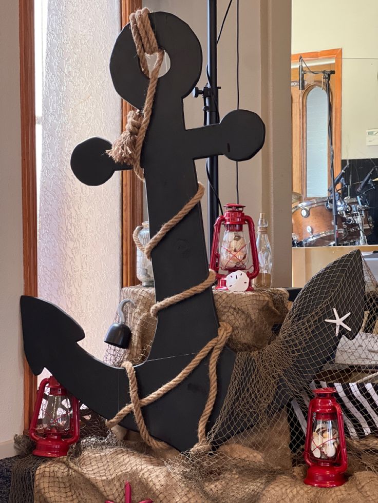 a boat made out of wood and rope on top of a burlap covered table