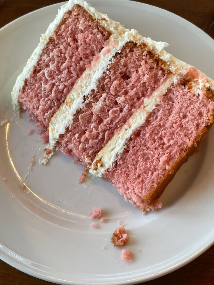 two slices of pink cake on a white plate