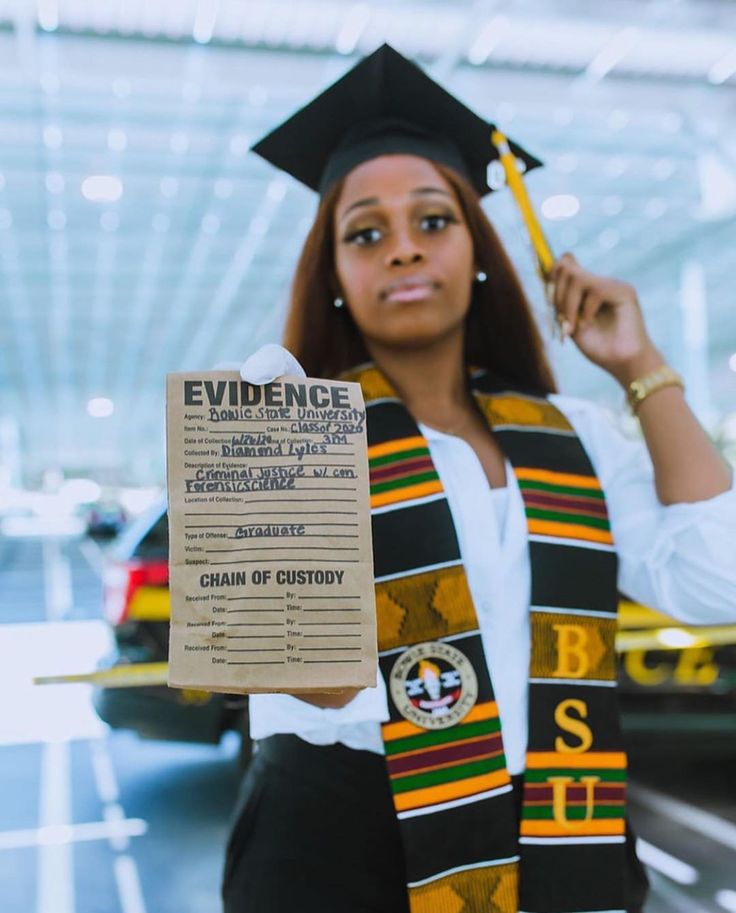 a woman wearing a graduation cap and gown holding up a paper with the words evidence on it