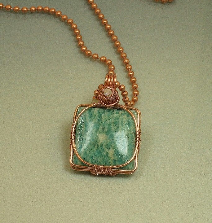 a necklace with a green stone on it