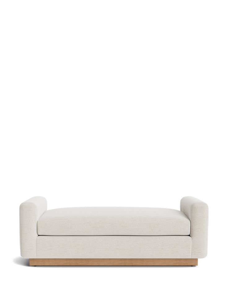 a white couch sitting on top of a wooden frame