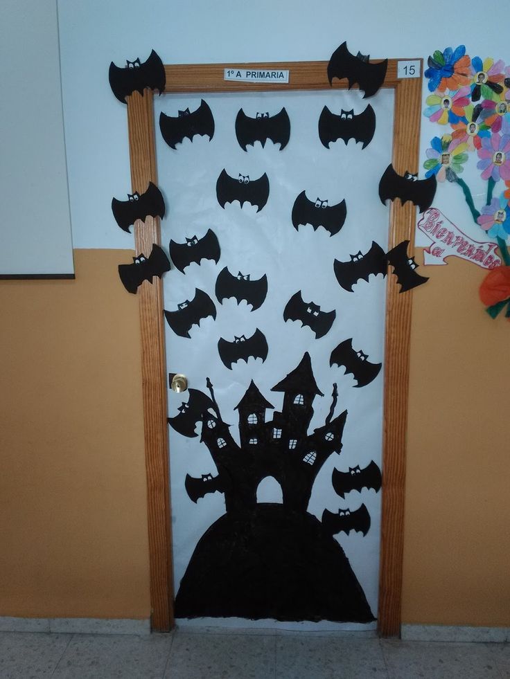 a door decorated with black bats and a crown