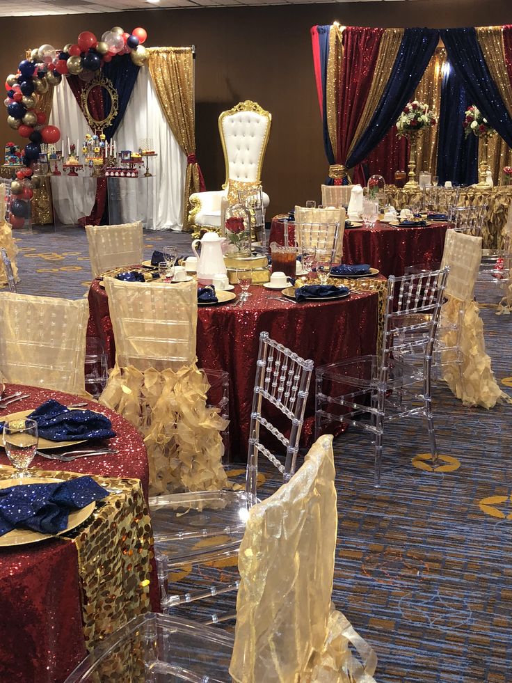 a banquet room set up with red, white and gold decorations