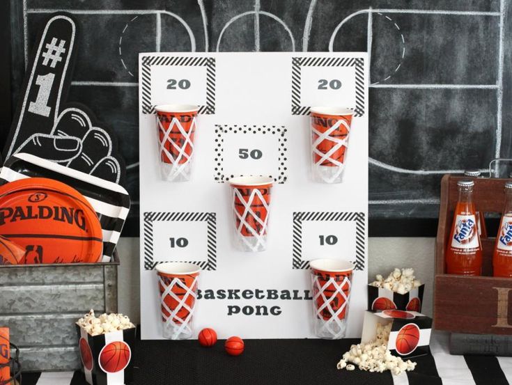 an orange and black basketball themed party with popcorn buckets, soda bottles and sports memorabilia