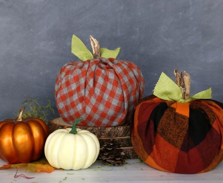 three decorative pumpkins sitting on top of a table