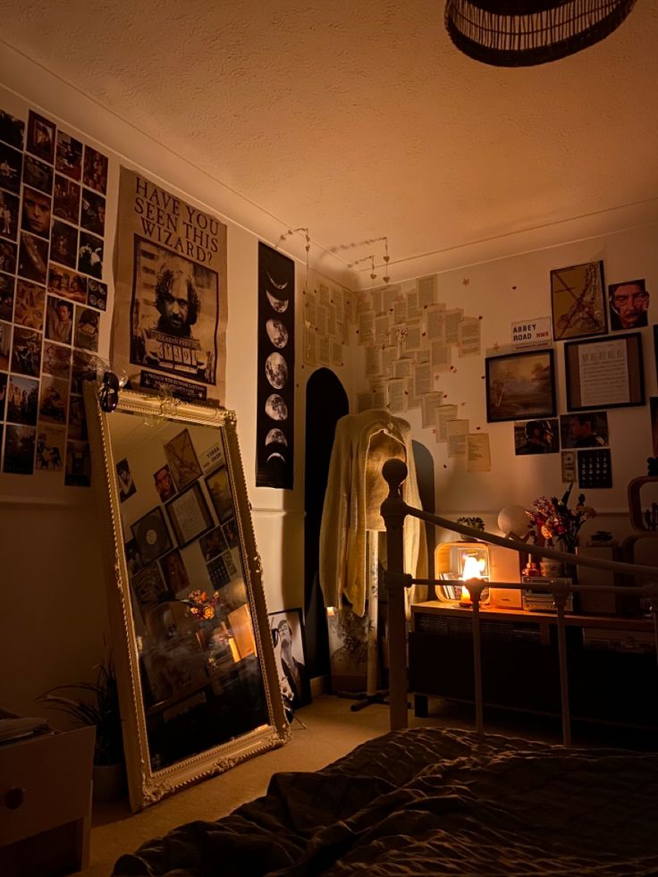 a bed room with a large mirror and pictures on the wall next to each other