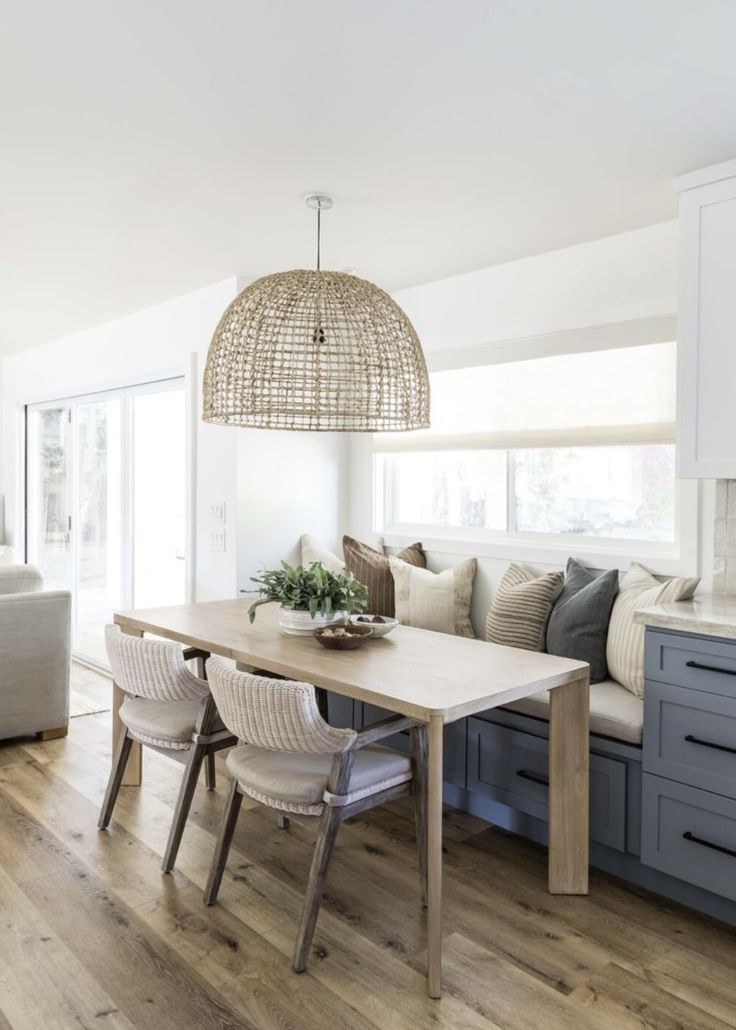 a dining room table with chairs and a bench