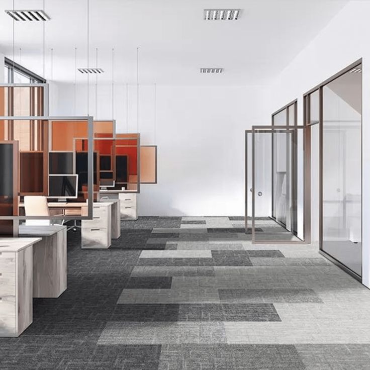 an empty office with cubicles and desks on each side, all lined up against the wall