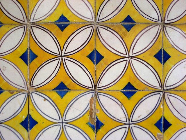 a yellow and white tile with circles on it