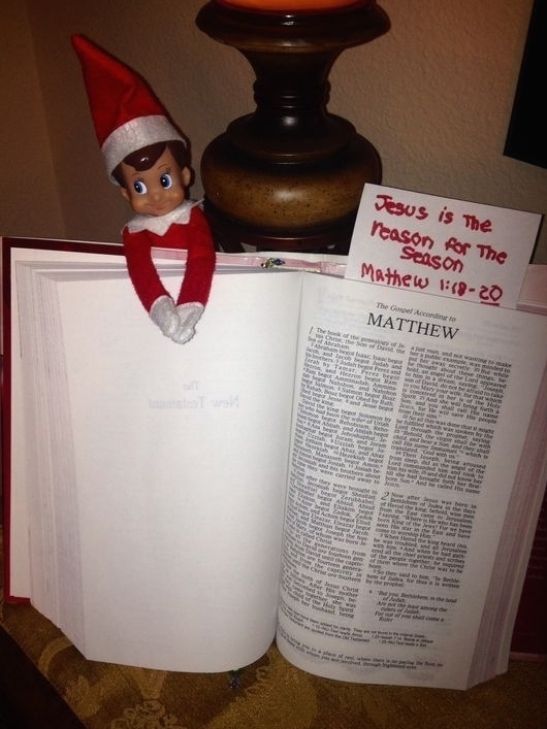 an open book with the elf on top of it