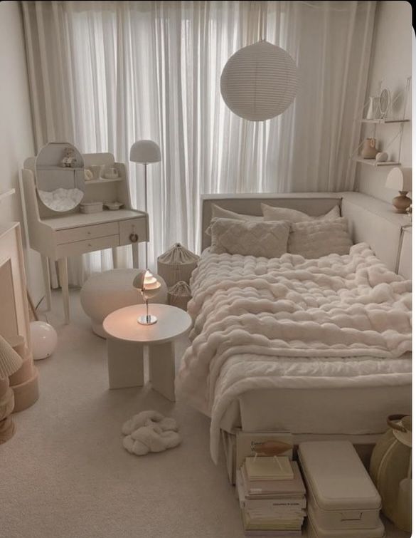 a bedroom with white furniture and curtains