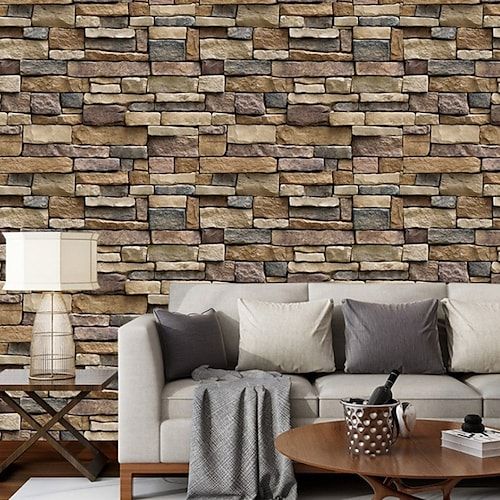 a living room with stone wallpaper and couches in front of a coffee table