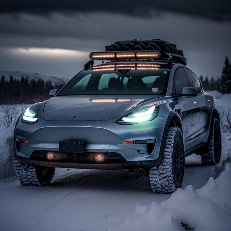 a car with lights on driving through the snow