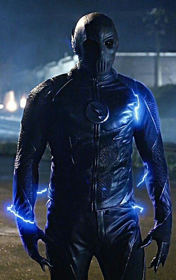 a man in a black suit with blue lights on his face