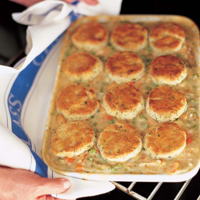 a person is holding a tray with food on it