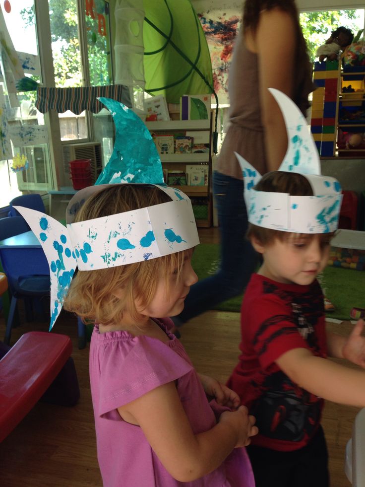 two young children wearing paper crowns on their heads