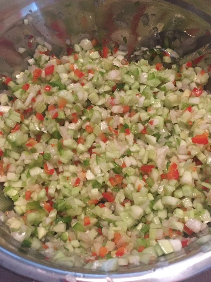 chopped vegetables are mixed in a bowl on the stove top, ready to be cooked