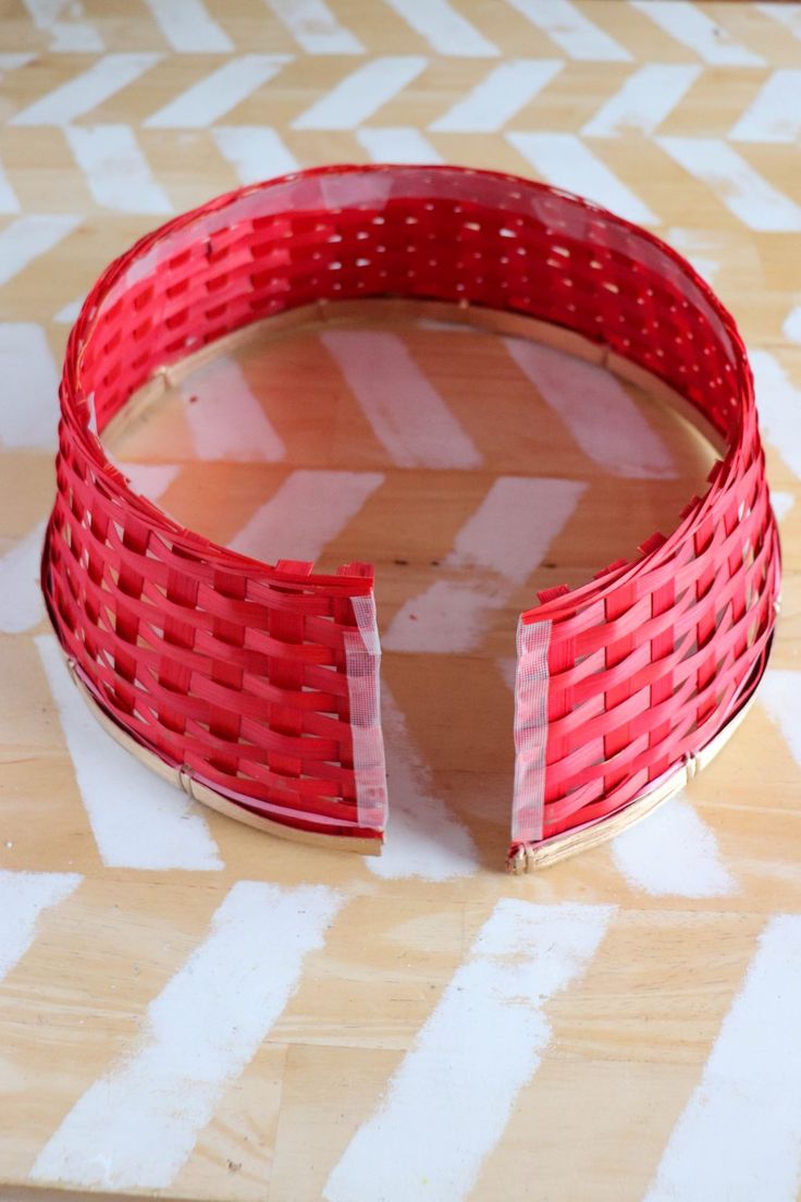 a red basket sitting on top of a wooden table